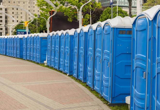 a line of brightly-colored portable restrooms, perfect for outdoor festivals and concerts in Indian Springs